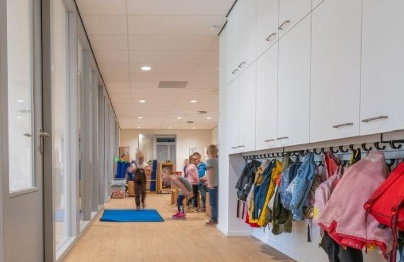 Primary and intermediate school cleaning A primary school corridor lined with coat hooks and children's bags