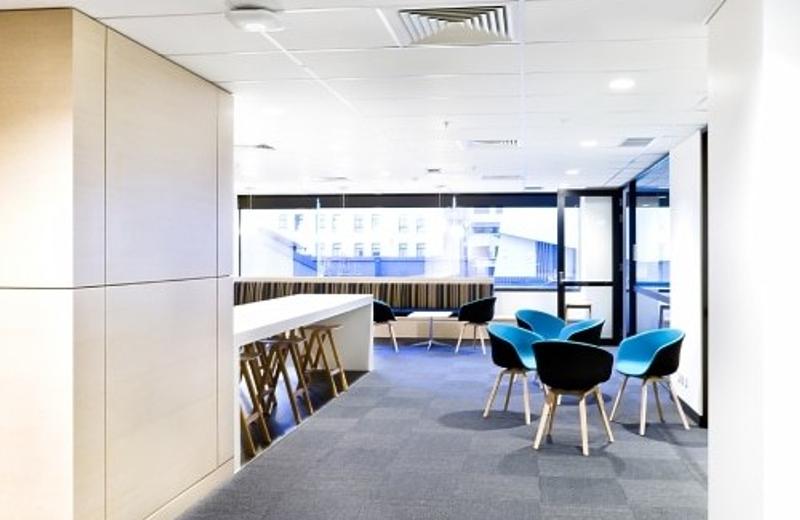 Professional cleaning for tertiary institutions A tertiary campus common area with grey carpet and blue chairs