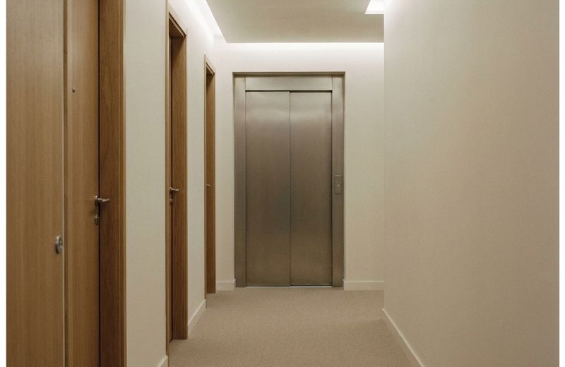 What we clean A clean apartment building hallway with a lift and doors along one side